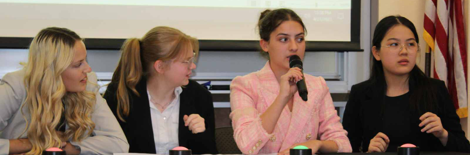 Four students talking at a table