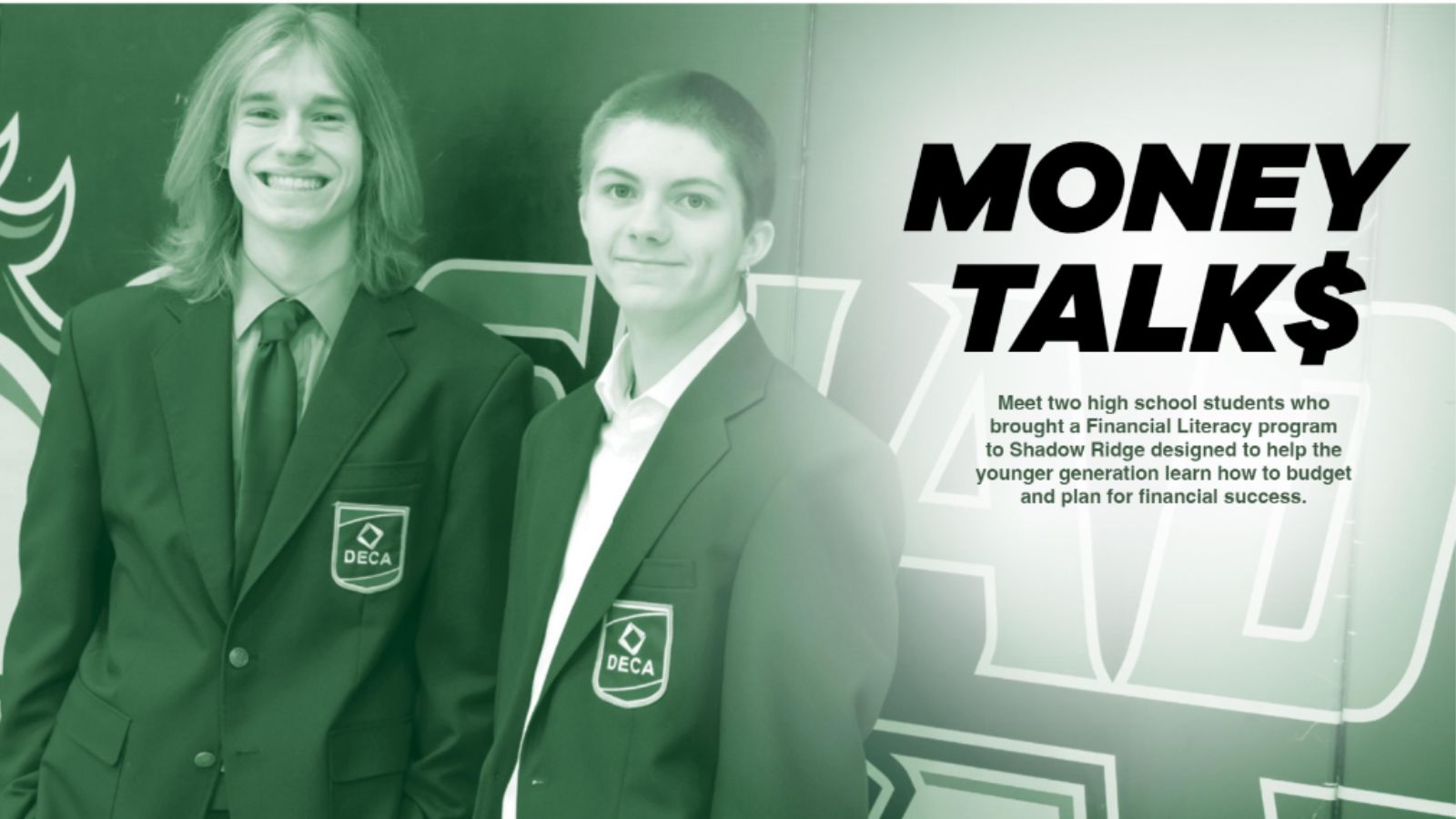 Two students wearing suit jackets standing in front of school logo. Image is tinted green.