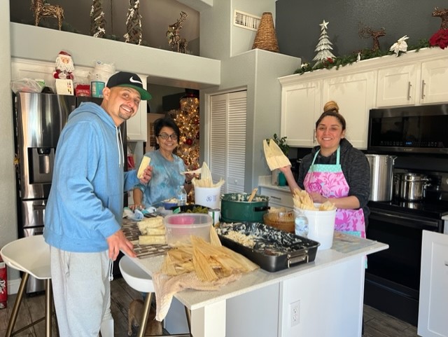 Photo of Heidi Vega and her family making tamales in a kitchen.